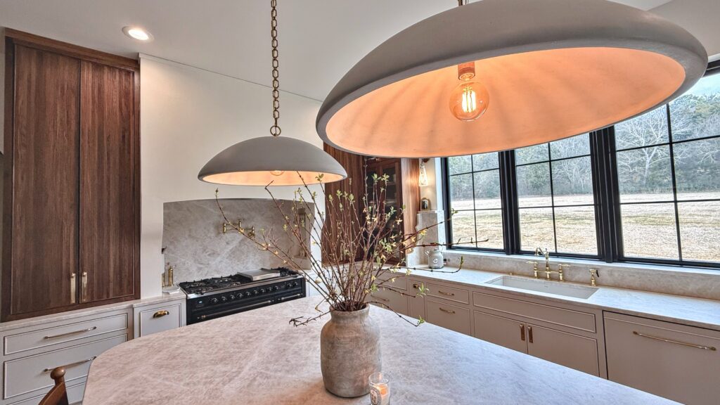 Custom cabinetry with a full-height pantry tower and stone counter built by Baltic Cabinets